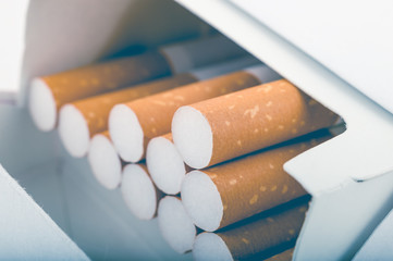 Side view of a pack of cigarettes with faded filter