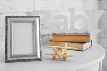 Toy with frame on white wall background