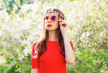 Fashion beautiful hippie woman in a spring flowering garden