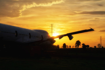 Fototapeta na wymiar Silhouette Airplane is park in garden at Thailand , Time sunset