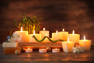 Fototapeta na wymiar Spa composition with candles on brown background
