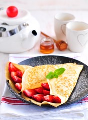 Pancakes with organic strawberries, caramel, cinnamon and mint.