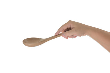 Hand holding a wooden kitchen spoon for stirring and tasting foo