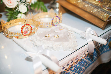 Pair of beautiful shiny wedding rings in church