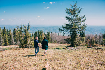 beautiful gentle loving couple against the sky in a mountainous area