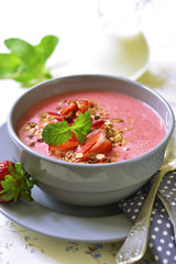 Strawberry oat smoothie in a gray bowl .