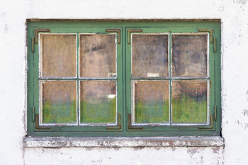 Weathered rustic window with green frames
