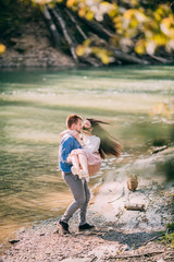 Young couple in love outdoor.Stunning sensual outdoor portrait of young stylish fashion couple posing in summer near the river