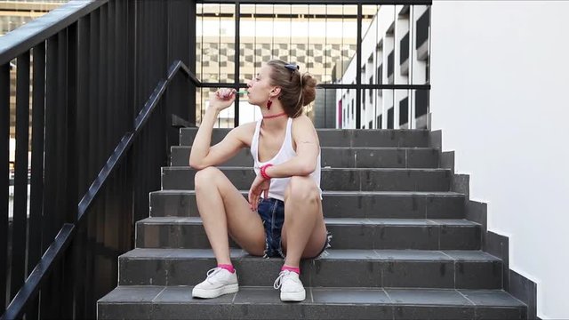 Young sexy girl eating lollipop outdoors. Fashion lifestyle