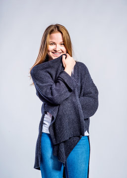Girl in jeans and long sweater, woman, studio shot