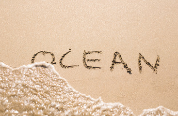 word OCEAN on the sand