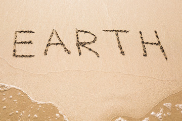 earth text on the sand