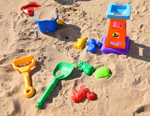 Fototapeta na wymiar Baby Toys on beach sand 