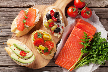 Toast sandwiches with avocado, tomatoes, salmon