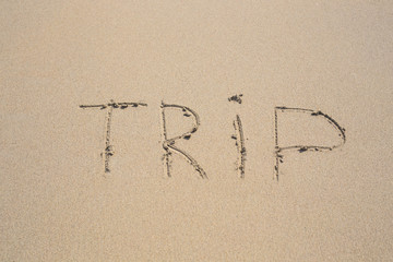 written words trip on sand of beach
