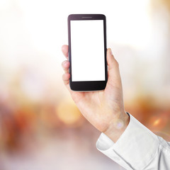 Hand shows mobile smart phone, blurred background