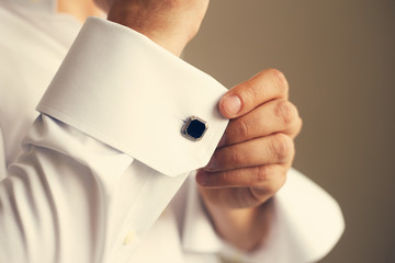 Man correcting the sleeve of his shirt