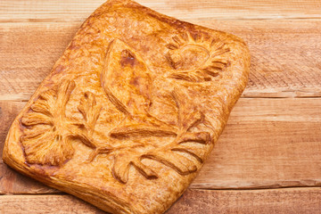 Pie stuffed with salmon on a wooden table