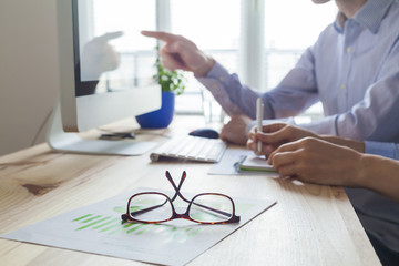 Meeting of business people in co-working space, close-up on glas