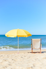 Fototapeta na wymiar Back View Of Deckchair, Sun Lounger Under Umbrella On Sand Beach. 