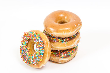 Glazed and sprinkles donuts isolated on white background