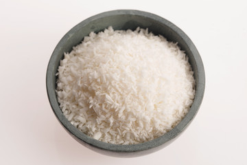 Coconut flakes in ceramic bowl