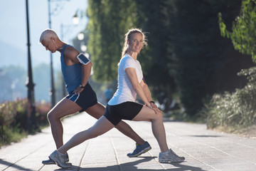 couple warming up and stretching before jogging