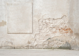 abandoned grunge cracked brick stucco wall with a stucco frame - 112162682