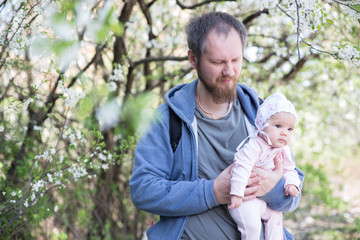 Father and daughter under tree. Soft focus