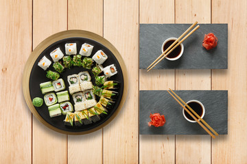 Fototapeta na wymiar Set of sushi maki and rolls at wood.