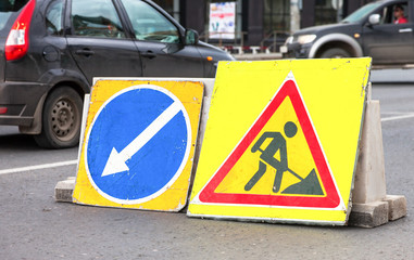 Road signs at the under construction road in summer day