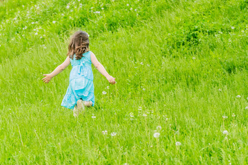 Fototapeta premium Beautiful child girl in spring park. Happy kid having fun outdoo