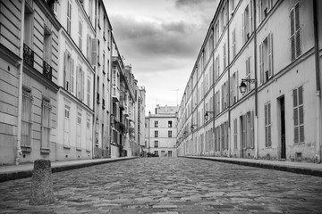 Naklejka premium Deserted street in Paris on a cloudy day