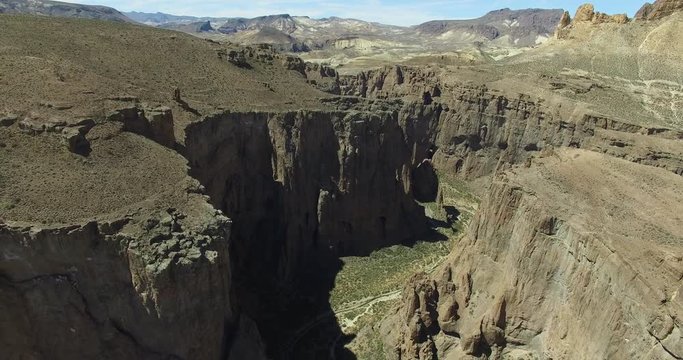 Aerial drone scene of big canyon in dry, arid climate, chubut, argentina, patagonia. Piedra parada. High altitudes through the cliffs, valey of the monumental natural hazard.
