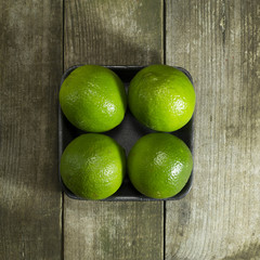 packed limes on a wooden background