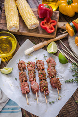 marinate beef kebabs on wooden table