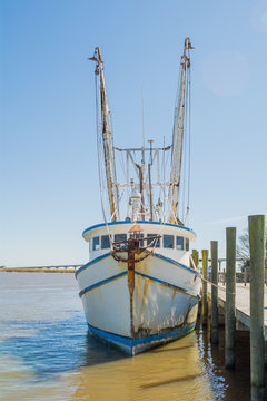 Shrimp boat tied to pier