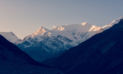 Fototapeta premium Snow covered mountain ridge at sunrise.