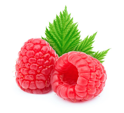 Two ripe raspberries with green leaf isolated on white background with clipping path