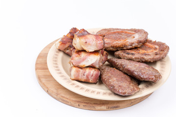 Served grilled meat on the plate over white background