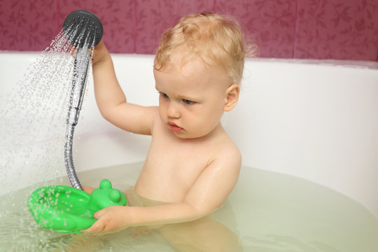 Cute Baby Boy Taking Shower In Bathroom