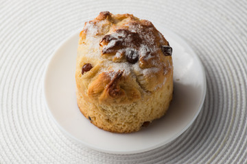 Homemade carrot muffin with empty space on white fabric background. Copyspace top view
