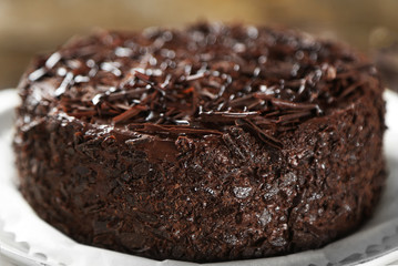 Tasty chocolate cake on wooden background