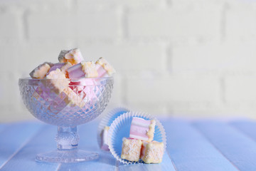 Tasty marshmallows with chocolate in bowl on table, close up
