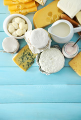 Set of fresh dairy products on blue wooden table, close up