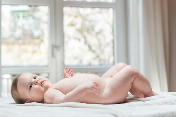 Obraz na płótnie Canvas Little naked baby girl lying down