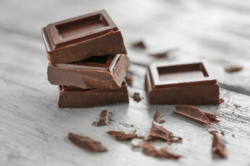 Chocolate pieces  on wooden background
