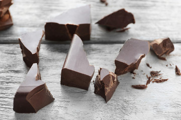 Chocolate pieces on wooden background