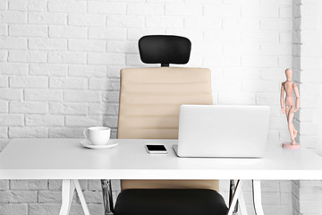 Modern workplace with office chair and laptop