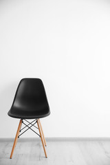 Cozy chair on wall background